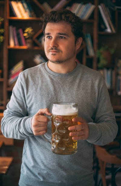 istock Handsome Man Drinking Beer at the Pub 1301920760