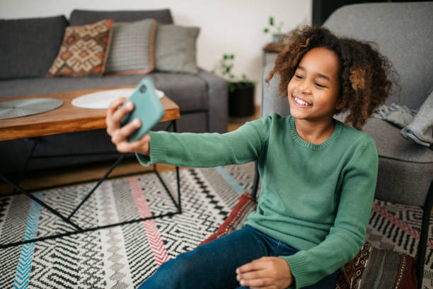istock Young African American girl using a smart phone 1301921193