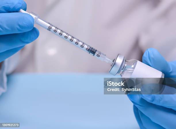 Doctor In Protective Medical Gloves Holds A Vial With A Vaccine And A Syringethe Concept Of Medicine Healthcare And Sciencecoronavirus Vaccinecopy Space For Text Stock Photo - Download Image Now