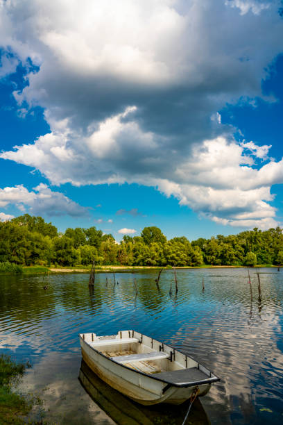 istock Small boat on the calm lake 1301921960