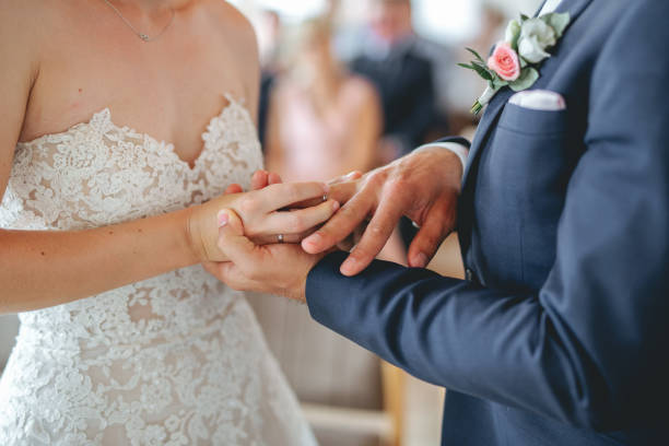 Bride and groom exchanging rings at their wedding ceremony