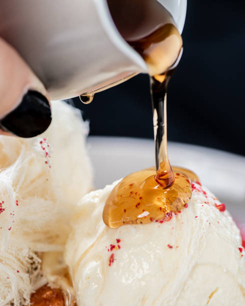 istock Maple syrup is being poured onto a plate of Ice cream 1301923169