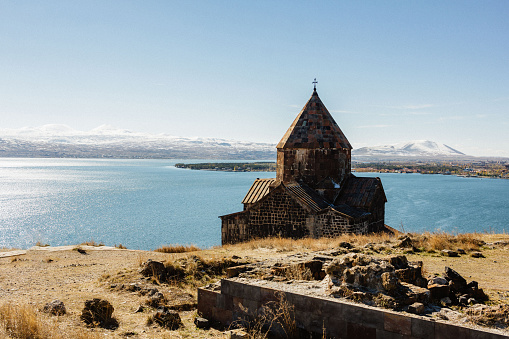 Old Armenian church at Sevan Lake background