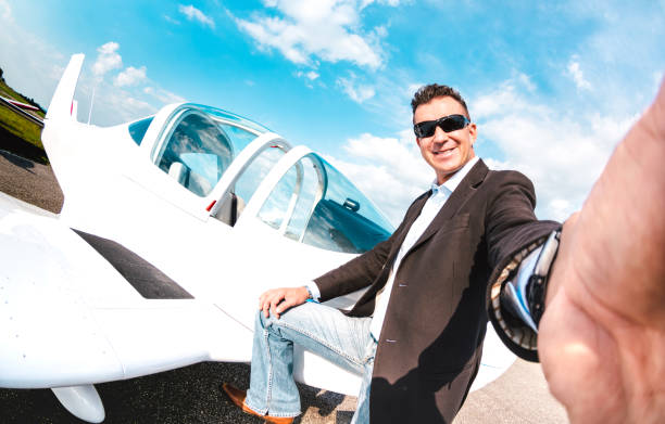 Young confident man taking selfie with mobile smart phone at private airplane - Modern business concept with rich guy ready for luxury excursion Young confident man taking selfie with mobile smart phone at private airplane - Modern business concept with rich guy ready for luxury excursion ultralight photos stock pictures, royalty-free photos & images
