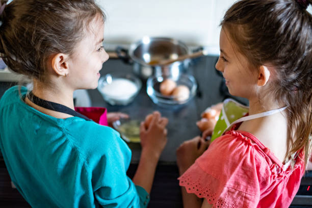 istock Two girls cooking in kitchen 1301929290