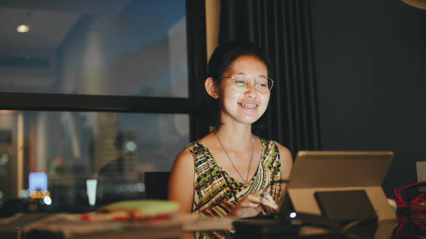 istock Asian daughter cheerful enjoy video call study , The school has been closed during coronavirus outbreak and the classes have moved to e-learning platform. 1301930116