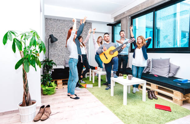 istock Young people employee workers having a break at start up coworking space - Fun business concept of human resources having relax time on working place - Startup entrepreneurs dancing at office party 1301931238