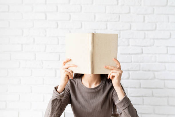istock Woman in casual clothes reading a book 1301931284