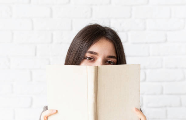 istock Close up of woman reading a book 1301932610