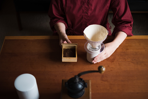 Asian woman enjoying a coffee ritual at home.
A photo taken in Tokyo, Japan.