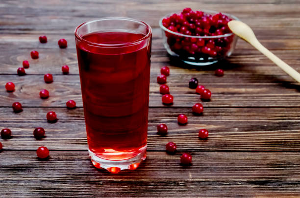 glasses of fresh cranberry drink. selective focus - cranberry juice imagens e fotografias de stock