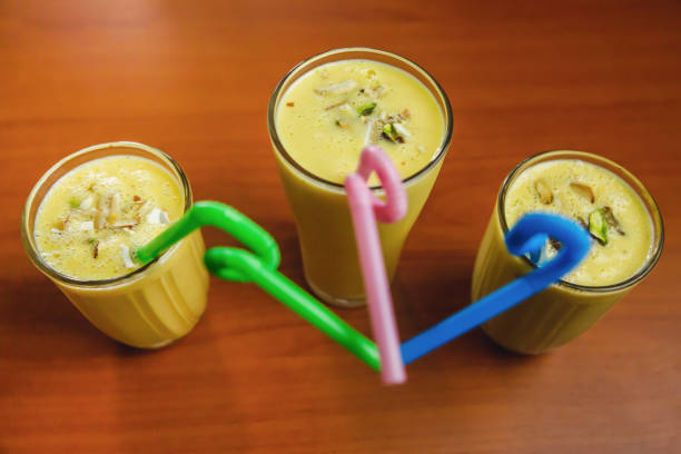 istock Homemade Fresh Mango Lassies garnished with Nuts and Straws 1301934732