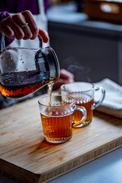 istock Woman is making hot tea in the kitchen. 1301935800
