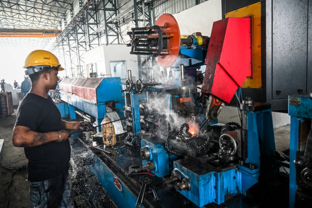 Steel tubes welding in a factory. Iron tube welding in a factory in India. High efficiency switch welder operating in Raipur, India. automatic welding torch stock pictures, royalty-free photos & images