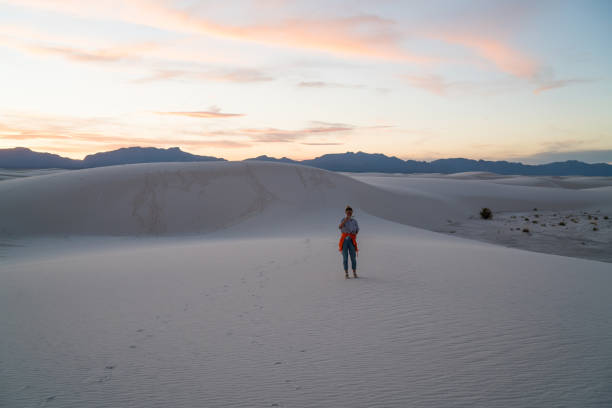 istock Unrecognizable woman in white sand desert 1301939626