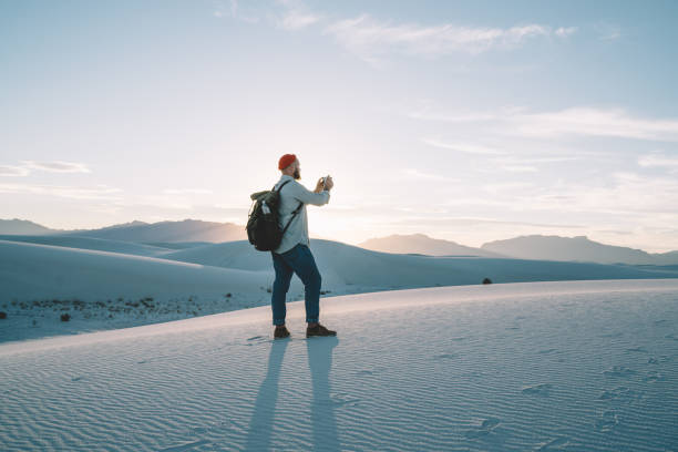 istock Anonymous man standing on sandy hill in desert 1301939641