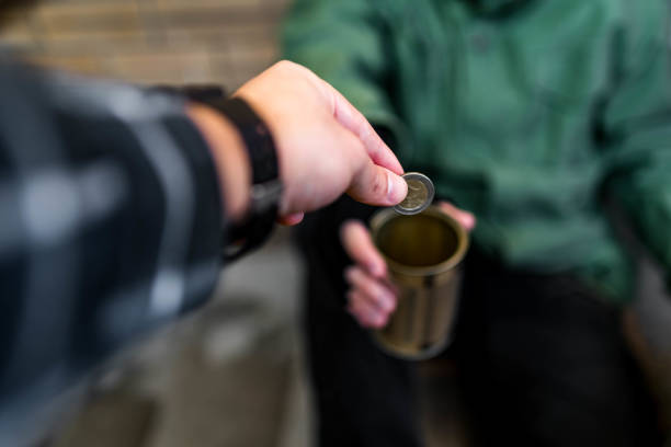 Homeless man receiving money Poor homeless man receiving money donation beg alms stock pictures, royalty-free photos & images