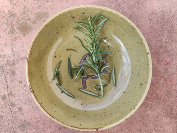 istock Single rosemary on a yellow-brownish saucer 1301942272