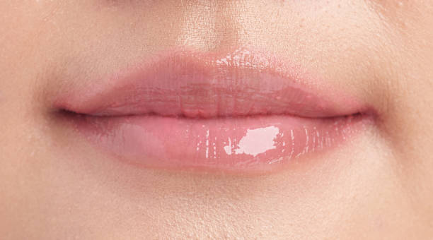 istock closeup Lips, Beautiful young woman with pink lipstick, 1301942425