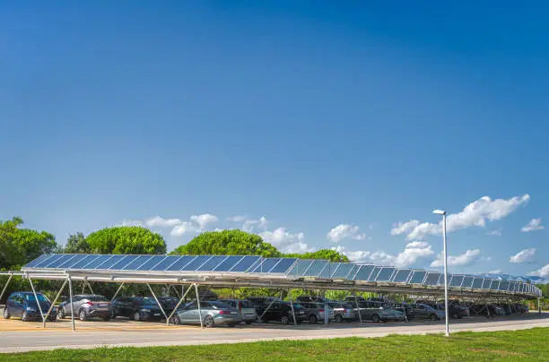Large carpark with solar panels on the roof to charge cars with ecological, renewable energy, Zaton in Croatia. Large copy space above