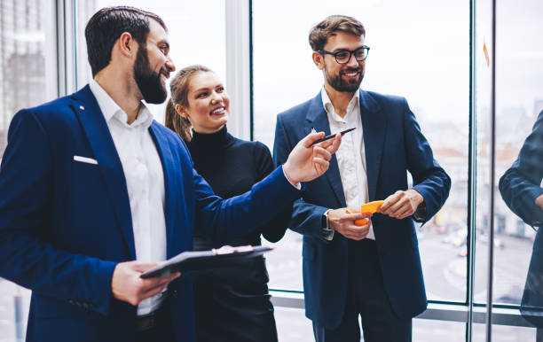 istock Group of Caucasian professional experts collaborating on startup ideas for creative projecting, successful male and female employees discussing business information in modern office workspace 1301944003