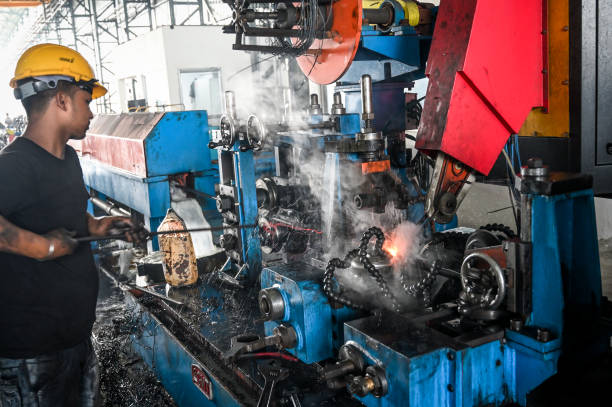Iron tube welding in a factory in India. High efficiency switch welder operating in Raipur, India.