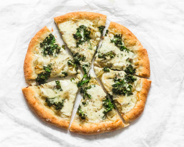 istock Slice of vegetarian potato, kale cabbage, mozzarella cheese pizza on a light background, top view 1301947334