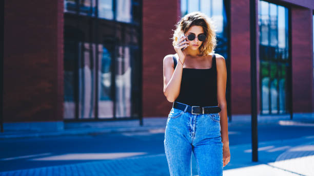 istock Thoughtful young female talking on cellphone outside 1301948533