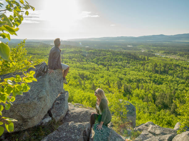 istock Hiking couple ascend sunny mountain ridge 1301950394