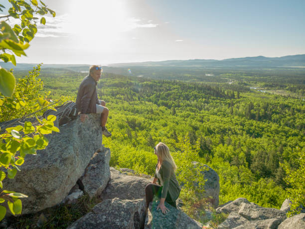istock Hiking couple ascend sunny mountain ridge 1301950450