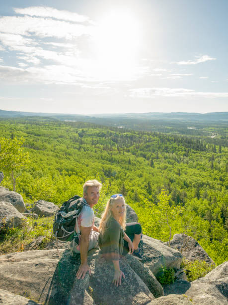 istock Hiking couple relax on sunny mountain ridge 1301951188