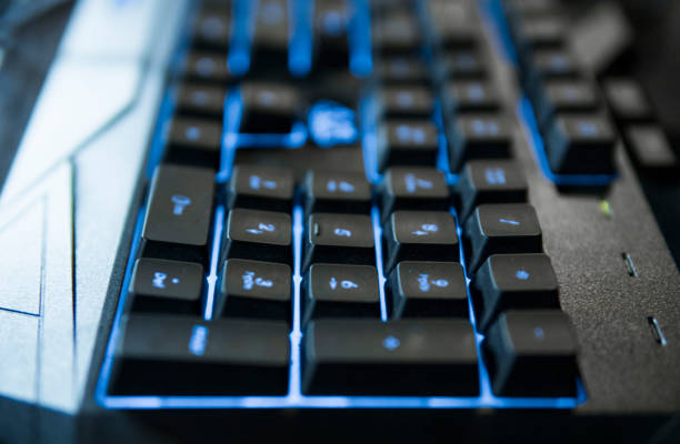 istock Gamer keyboard with colorful blue lights, modern gamer computer. Blue backlight, backlit on laptop or keyborad computer of gaming. 1301953589