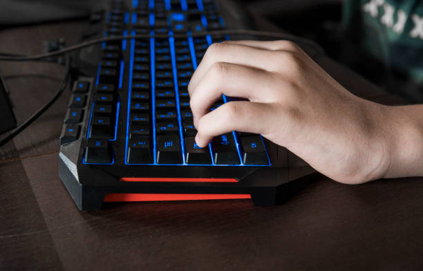 Gamer keyboard with colorful blue lights, modern gamer computer. Blue backlight, backlit on laptop or keyborad computer of gaming. Gamer keyboard with colorful blue lights, modern gamer computer. Blue backlight, backlit on laptop or keyborad computer of gaming keyborad stock pictures, royalty-free photos & images