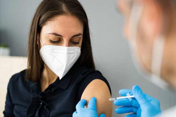Covid Vaccine Injection By Doctor Covid Vaccine Injection By Doctor In Face Mask covid 19 vaccine stock pictures, royalty-free photos & images