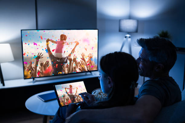 istock Family Watching TV Through Tablet Television 1301956836