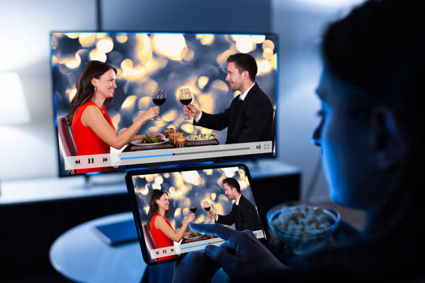 istock Woman Watching TV Through Tablet Television 1301956848