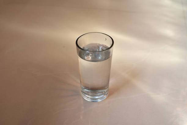 istock Glass of pure water on kitchen on white background and copy space. 1301960394
