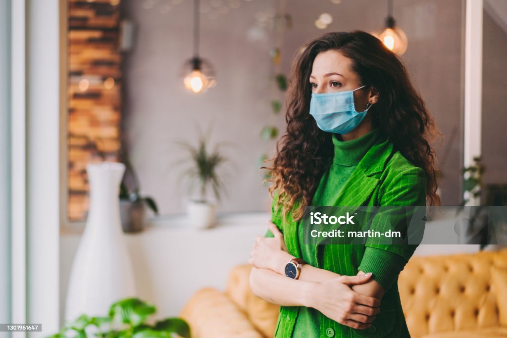 Businesswoman with protective face mask Businesswoman wearing protective face mask in the office during COVID-19 pandemic Employee Stock Photo