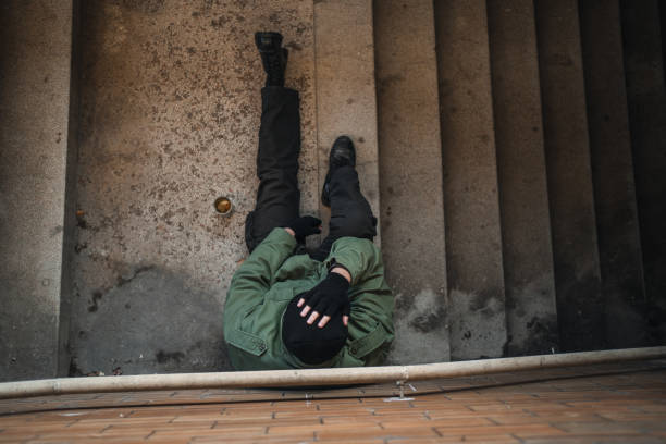 istock Homeless army veteran begging sitting on pavement 1301961871