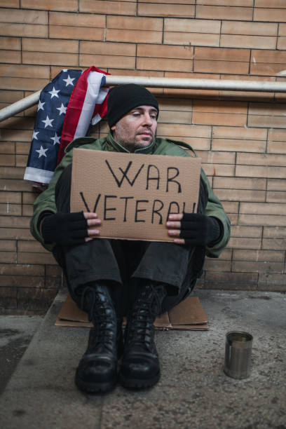 istock Desperate war veteran begging on the street 1301963077