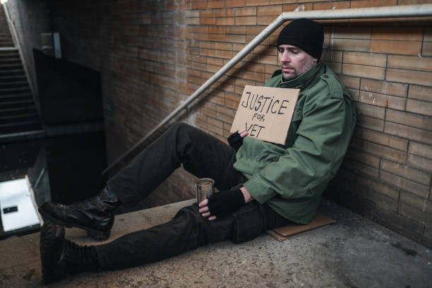 istock Army veteran begging on the street 1301963614