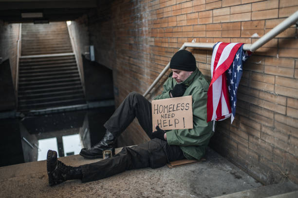 istock Homeless army veteran begging on the street needs Help 1301963703