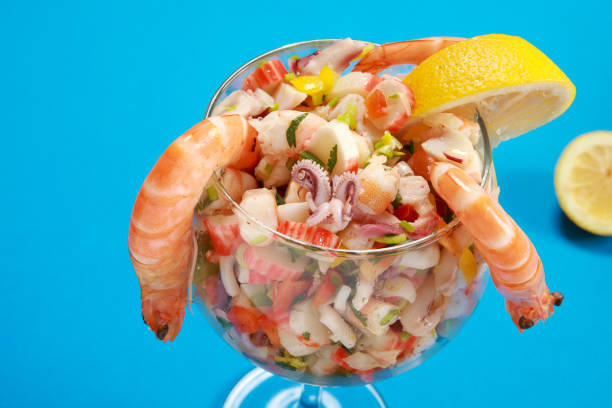 Delicious Peruvian Seafood Ceviche or Seviche Dish Delicious Peruvian Seafood Ceviche or Seviche Dish on colourful blue background crab leg photos stock pictures, royalty-free photos & images