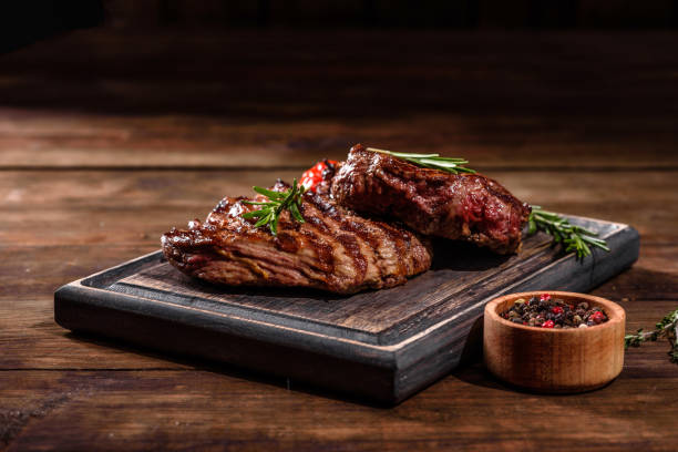 istock Fresh juicy delicious beef steak on a dark background 1301966149