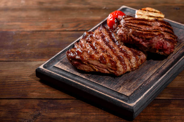 istock Fresh juicy delicious beef steak on a dark background 1301966151