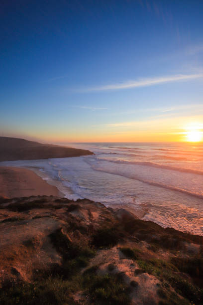 istock Amazing sunset in a beach with the ocean in background. 1301967445