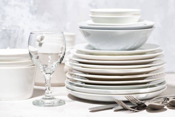 istock tableware, cutlery and glasses on a white table, closeup 1301968523