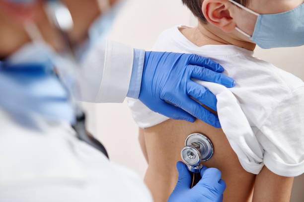 istock Close up of pediatrician using stethoscope, checking up heartbeat and lungs while auscultation in doctor office 1301972064