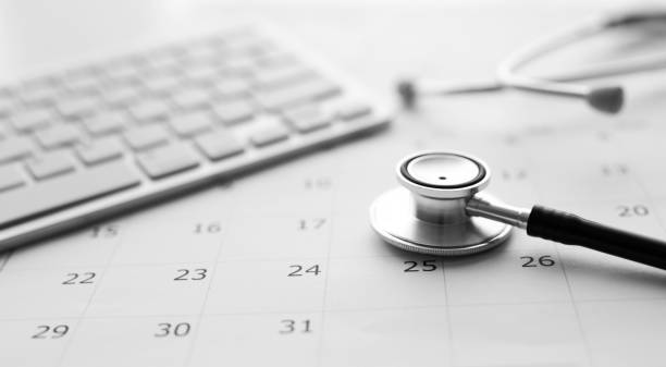 istock Annual checkup concept. Stethoscope on the calendar with soft-focus and over light in the background 1301974308