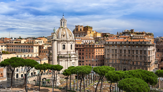 View at the Rome cityscape with Trajan Column and Santa Maria di Loreto church seen from Piazza Venezia in Rome, Italy.